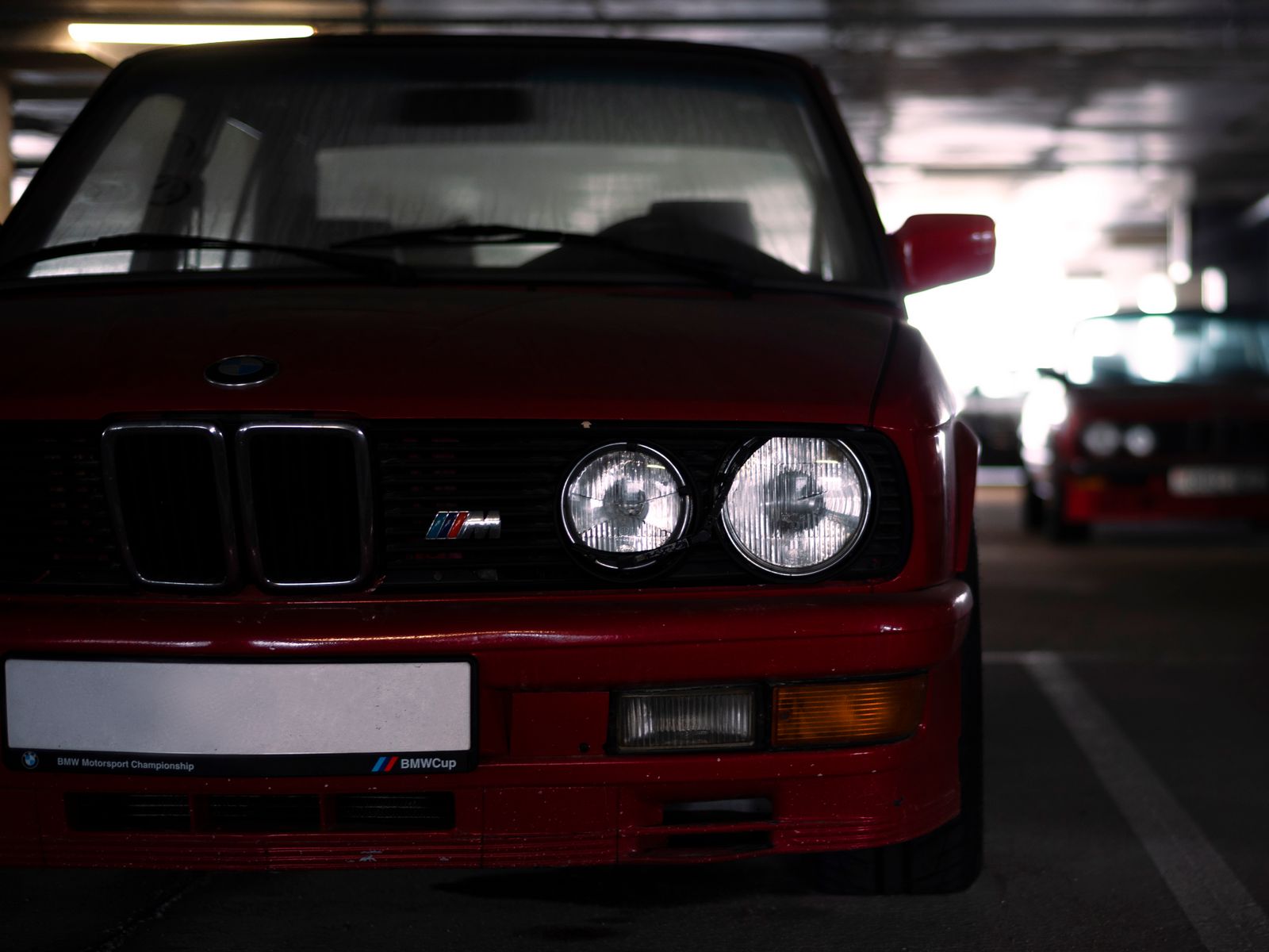 Vintage red BMW M series in a parking garage