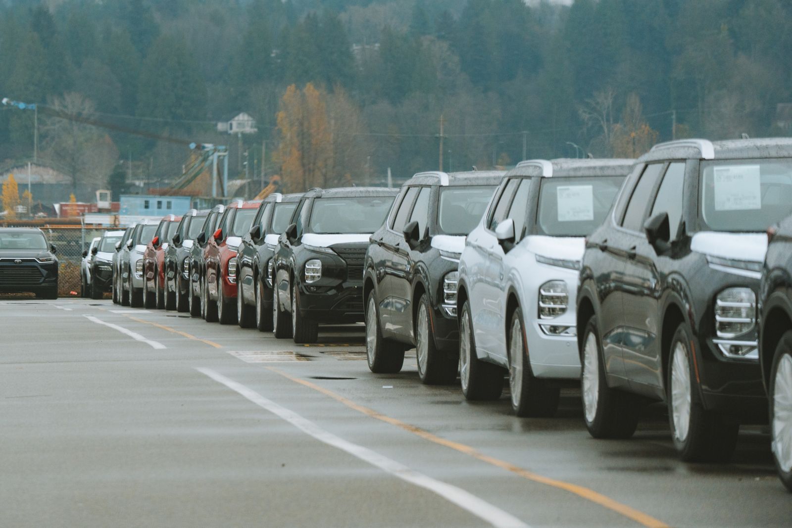 Line of new SUVs at an outdoor dealership lot, ready for sale