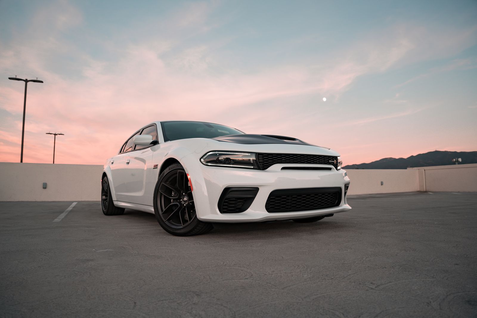 White Dodge Charger SRT Hellcat at urban sunset