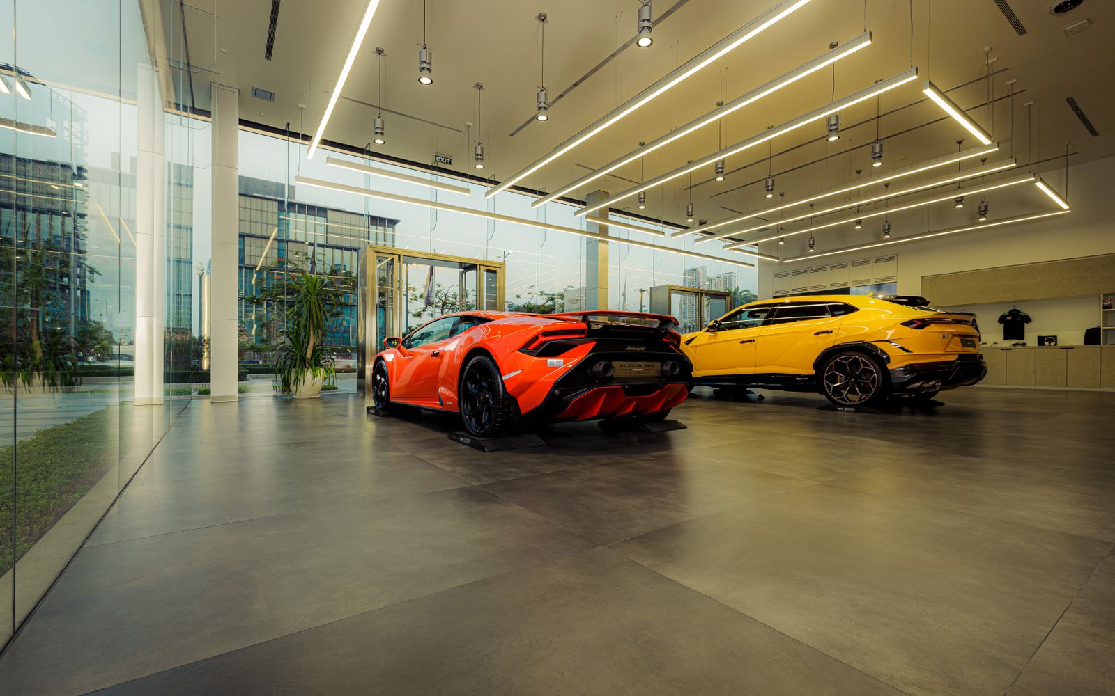 Luxury sports cars including Lamborghini in a modern showroom