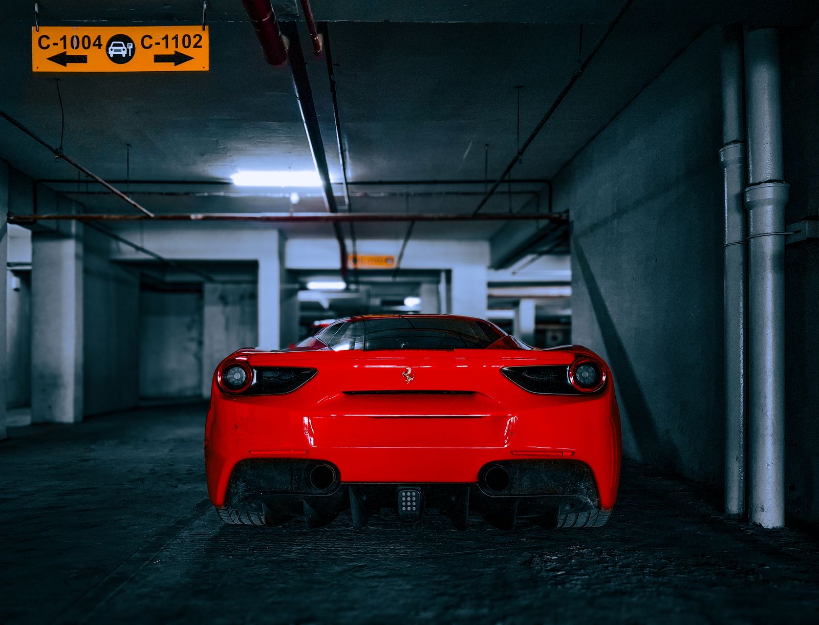 Red Ferrari 488 GTB in a showroom garage's Bayshore Boulevard