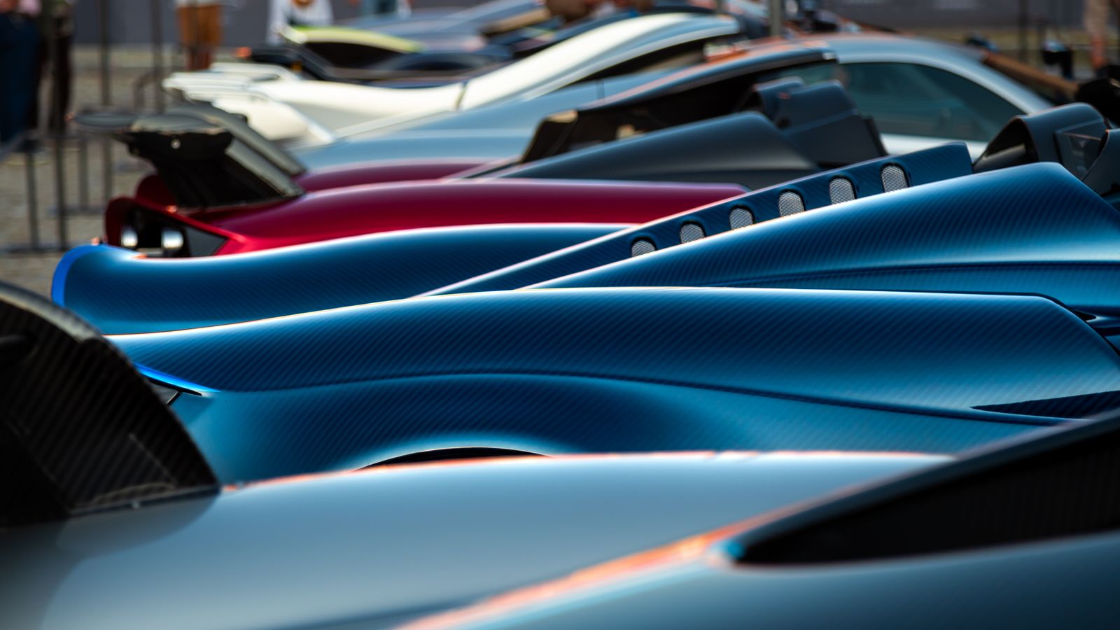 Display of sleek hypercars in vibrant colors