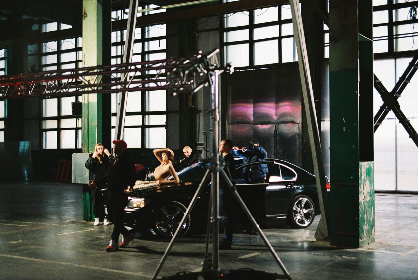 Behind-the-scenes view of a photoshoot with a luxury car