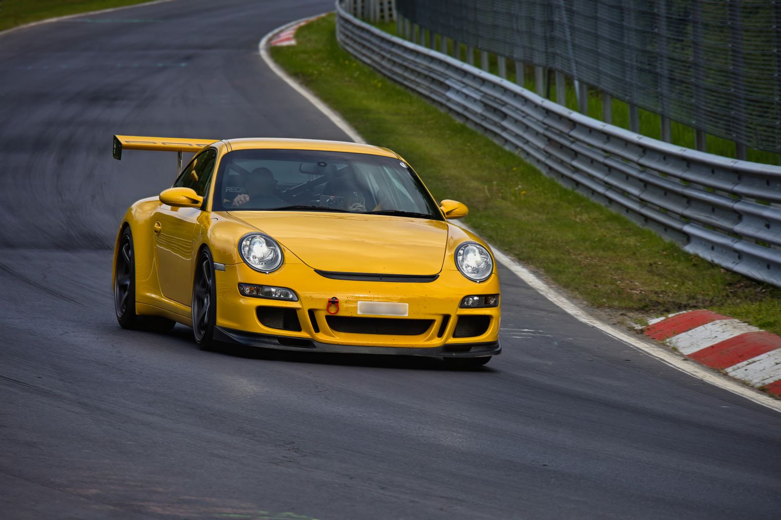 Yellow sports car speeding on a race track