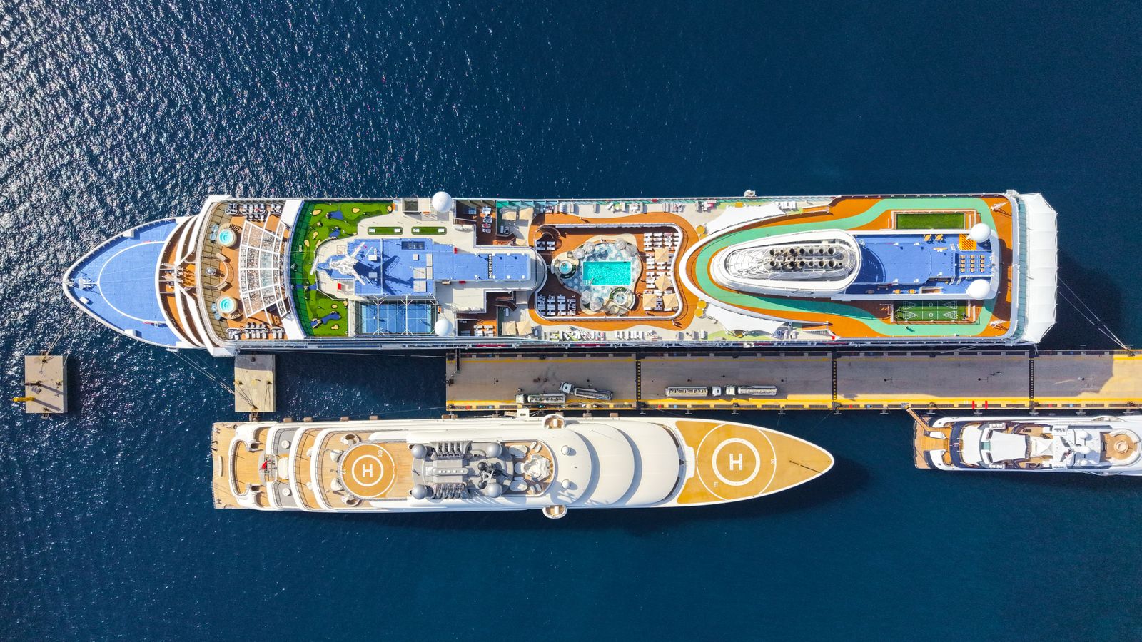 Top-down view of cruise ships moored at a sunny port
